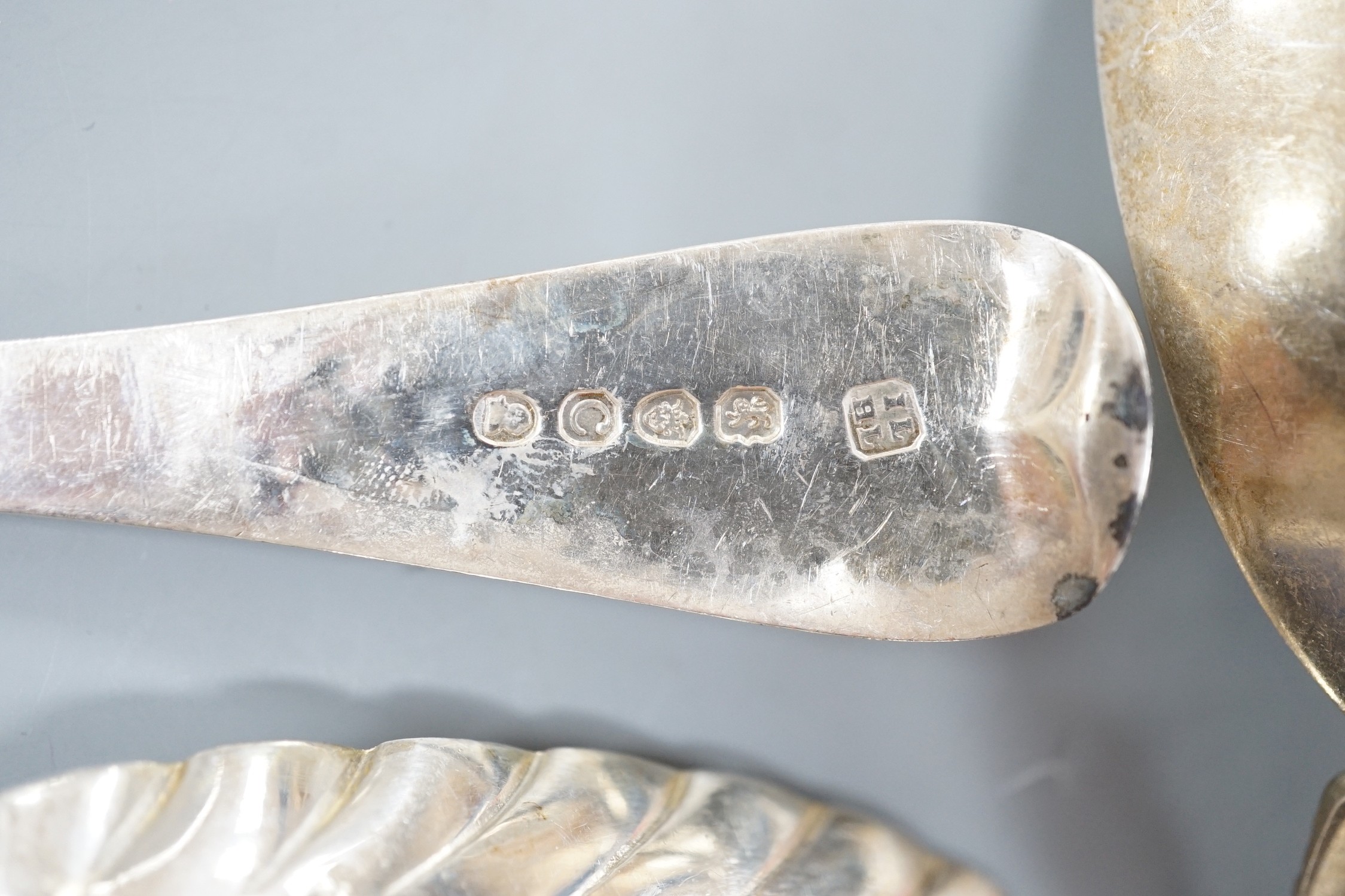 Two George III silver 'berry spoons', a pair of Victorian silver apostle serving spoons, Josiah Williams & Co, London, 1888, 19.8cm and a continental white metal spoon.